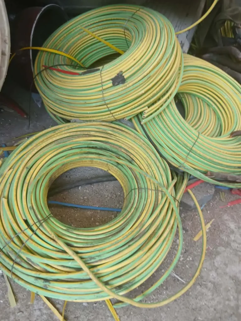 Coils of scrap green and yellow insulated electric wires ready for recycling in Makkah